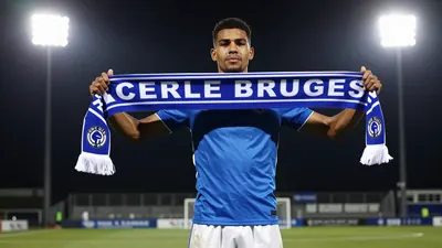 A photorealistic image of an anonymous Cercle Brugge player, wearing a blue jersey and white shorts, holding a Cercle...