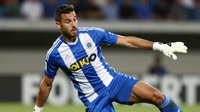 A photorealistic image of a 25-year-old, 1.85m tall, male Cercle Brugge player with a strong build, wearing a blue and...