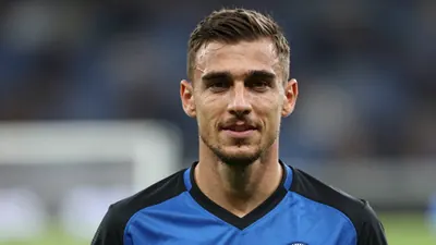 A photorealistic image of an anonymous Cercle Brugge player, aged 25-30, wearing a blue and black jersey made of smooth...
