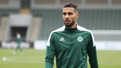A determined, 28-year-old Cercle Brugge midfielder with a strong build, wearing a plain dark green and white training...