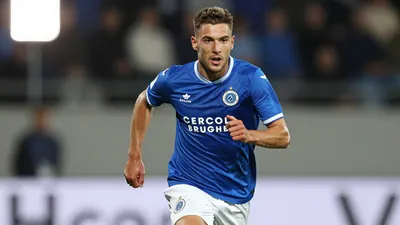 A photorealistic image of a Cercle Brugge B player in a blue jersey with white shorts, running with the ball, a young...