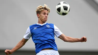 A tight action crop of a young, anonymous Cercle Brugge player in his early twenties, with a messy, sandy-blond haircut...