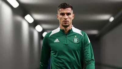 A 35-year-old, 5'10" Belgian defender in a dark green and white Cercle Brugge training top, made of a lightweight...