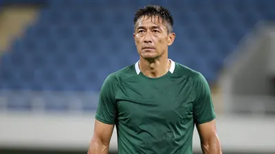 Middle-aged male physical coach, muscular build, mid-30s, waist-up, wearing a plain dark-green training top with white...