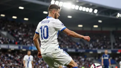 A photorealistic image of a Cercle Brugge player in a white jersey with a blue stripe, number 10 on the back, looking...