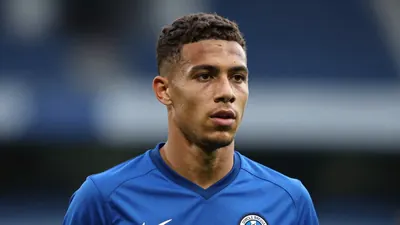 A young male footballer in his early twenties, wearing a solid blue Cercle Brugge training kit, head-and-shoulders shot...